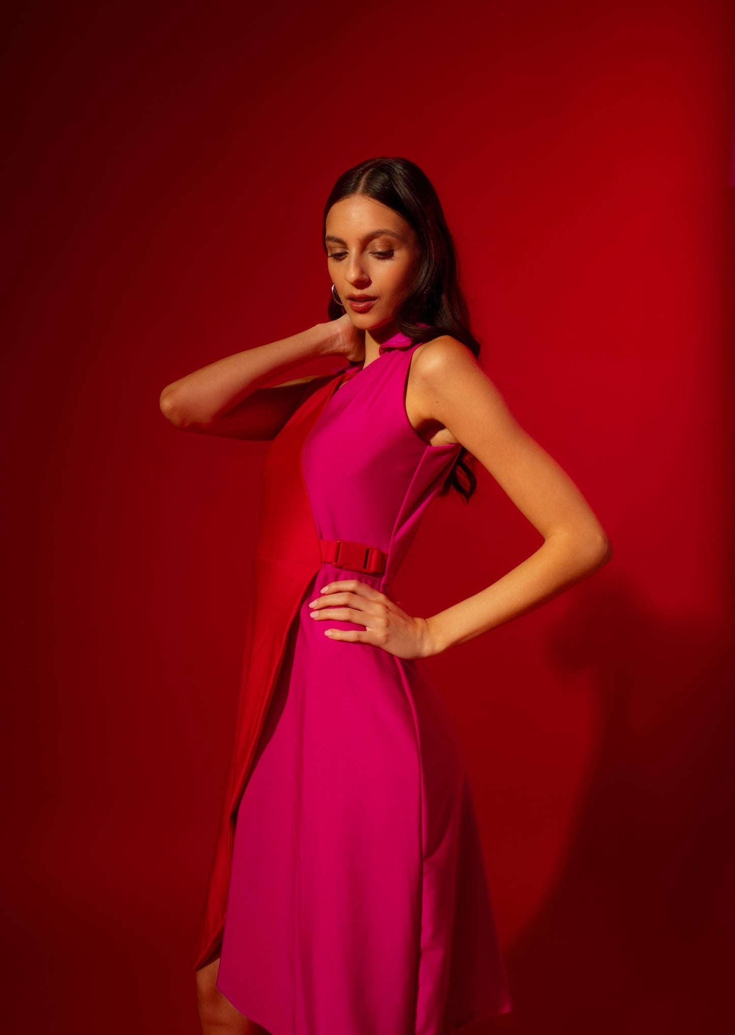 Woman wearing a pink dress against a red background