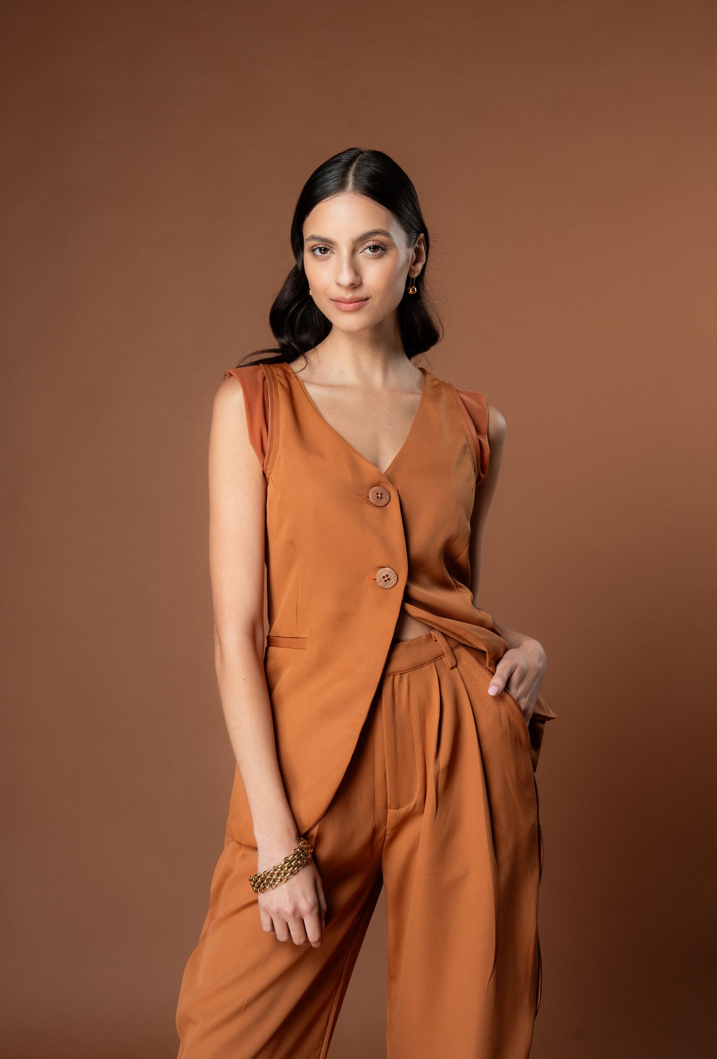 Woman wearing Rebel Roots Tan Capsule PowerSet. Powerset contains a Coord set of Tan Waistcoat and Tan Pants.