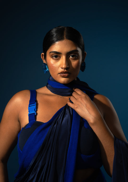 Woman wearing the Rebel Roots Buckle Sari in blue, a pre-draped saree, with the pallu draped over her shoulder
