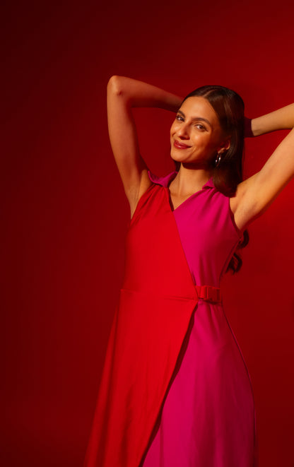 Woman in a two-tone dress posing against a red background