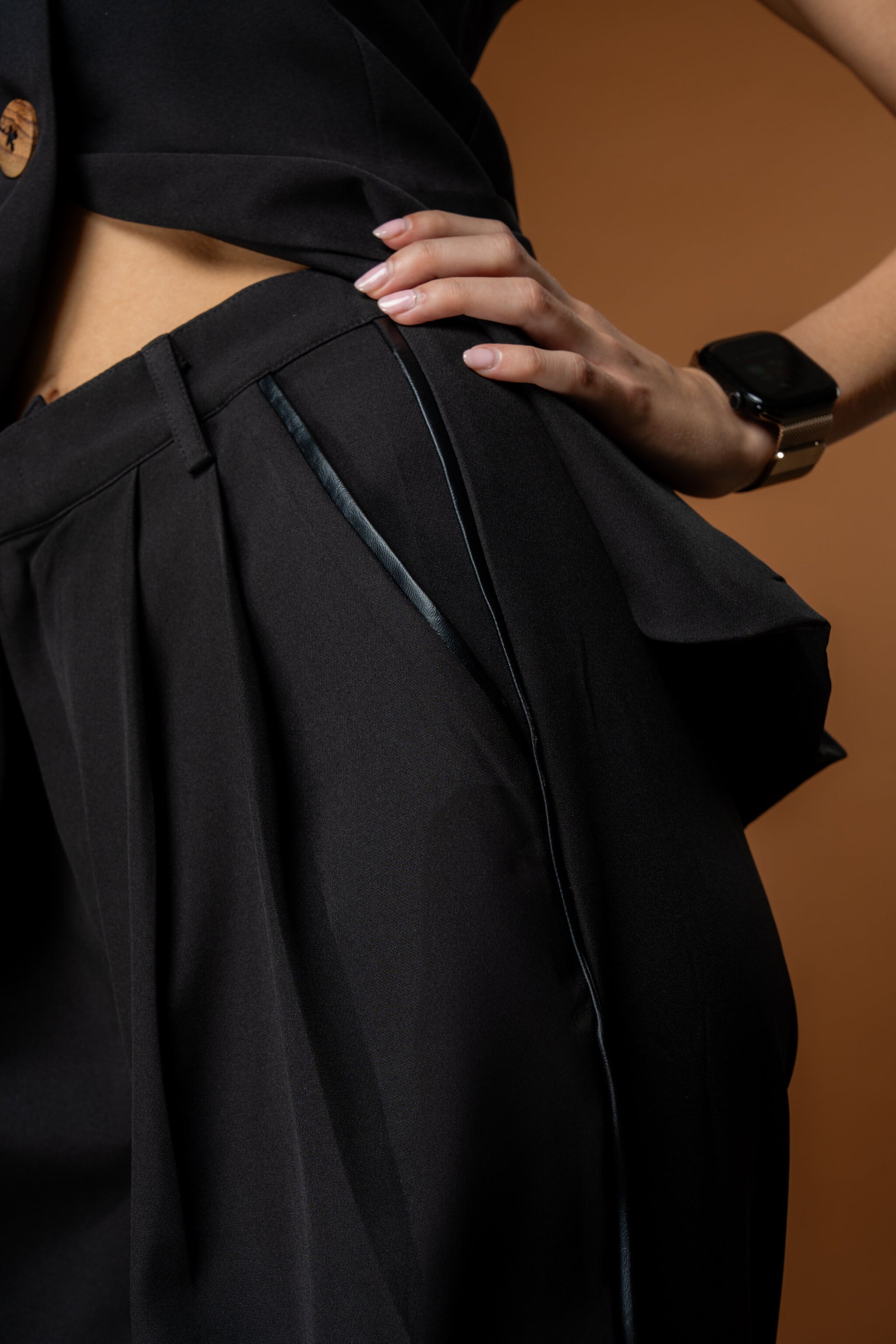 Person wearing a black Powerset from Rebel Roots- Black waistcoat and Black Trousers with leather work.