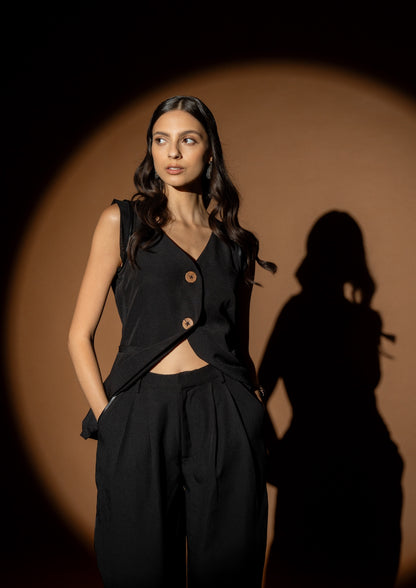 Woman wearing Rebel Roots Black Capsule PowerSet - Black WaistCoat and Black Trousers.