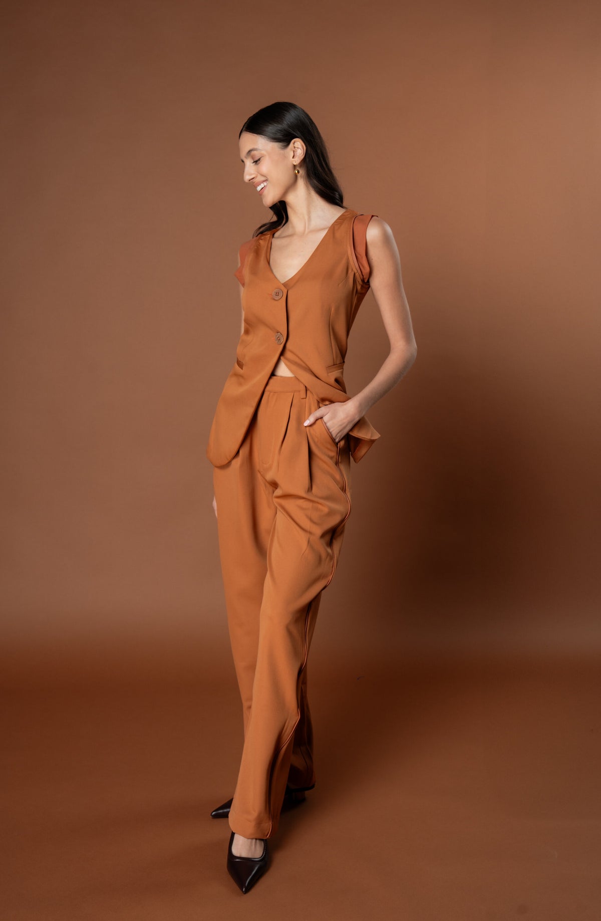 Woman wearing a Tan Waistcoat and Trouser Coord Set. This set is a part of the Capsule Powerset collection from Label Rebel Roots.