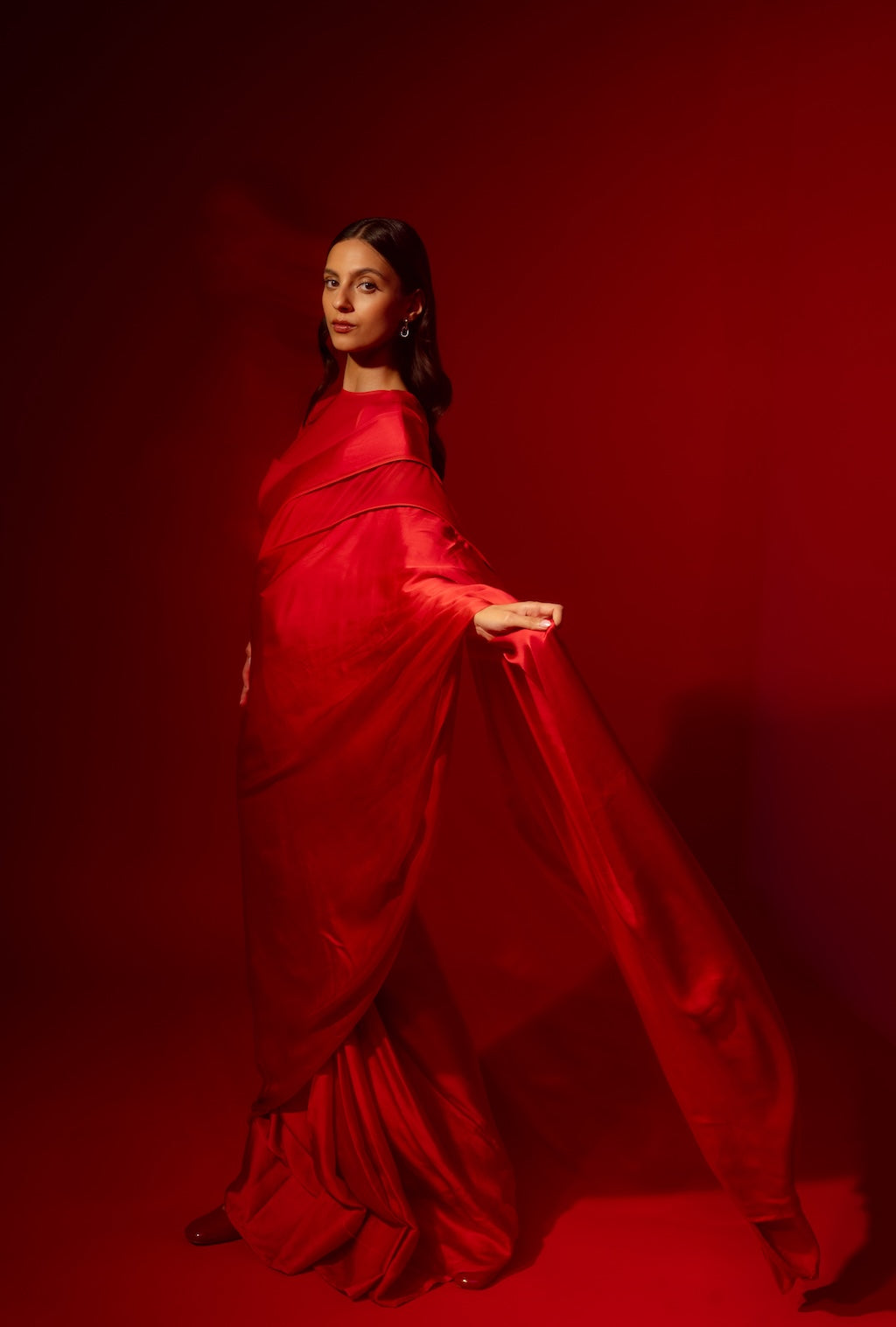 Woman posing in Rebel Roots Capsule Red Saree