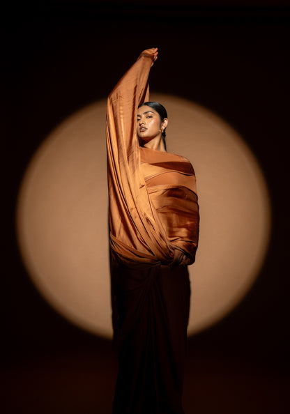 Person wearing Rebel Roots Tan Capsule Ready to Wear Saree. Woman stands under a spotlight comfortable in her saree.