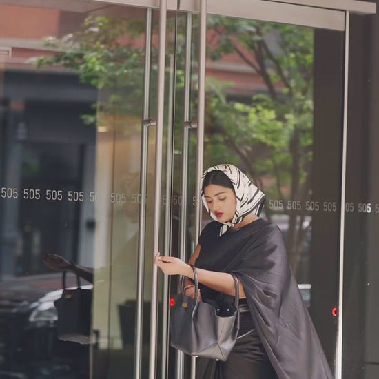 Modern Indian Woman ready for her daily workday in an easy and modern ready to wear black saree. The Black saree is a part of the Label Rebel Roots Capsule Saree Collection