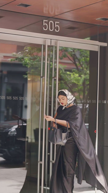 Modern Indian Woman ready for her daily workday in an easy and modern ready to wear black saree. The Black saree is a part of the Label Rebel Roots Capsule Saree Collection