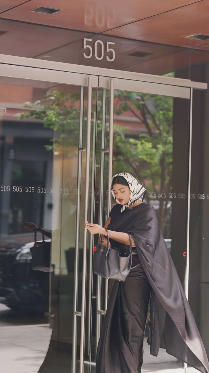 Modern Indian Woman ready for her daily workday in an easy and modern ready to wear black saree. The Black saree is a part of the Label Rebel Roots Capsule Saree Collection